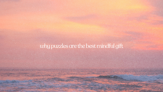 Soft pastel sunset over ocean waves with text reading “why puzzles are the best mindful gift.”
