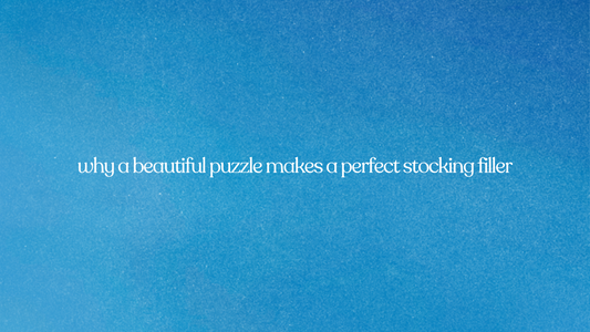 Text overlay on a bright, grainy blue background reads: "why a beautiful puzzle makes a perfect stocking filler."